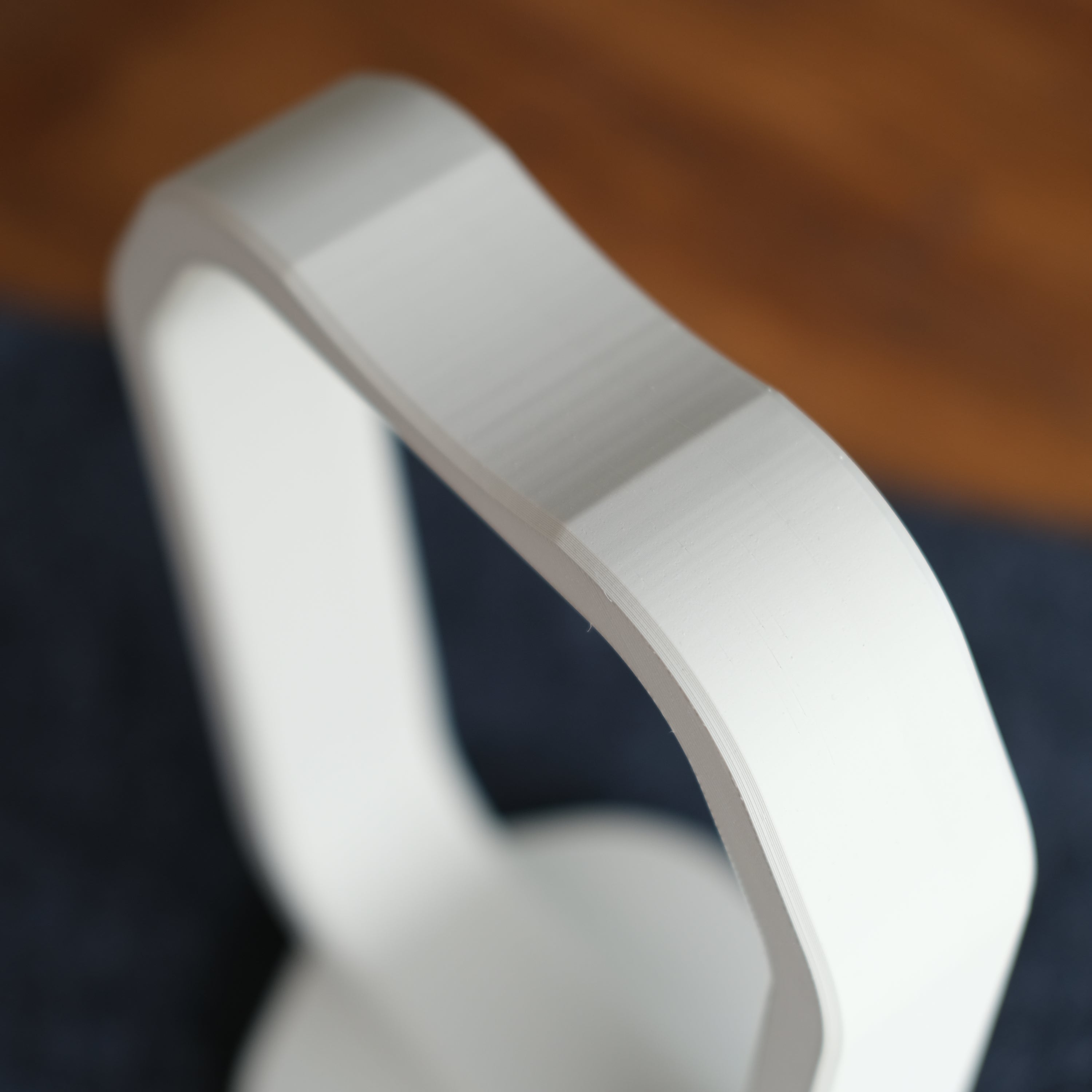 Close-up of a sleek Headphone Display Stand showcasing its modern design and smooth finish.